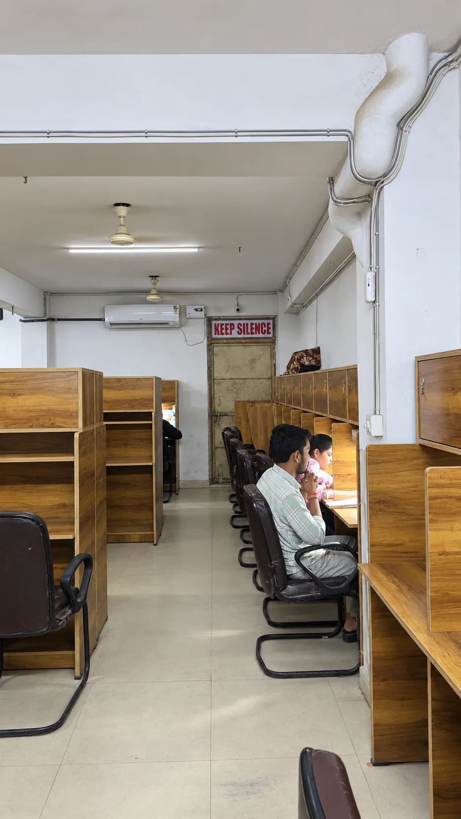 Students studying at personal cabin desks inside Adhyayan Library Gwalior