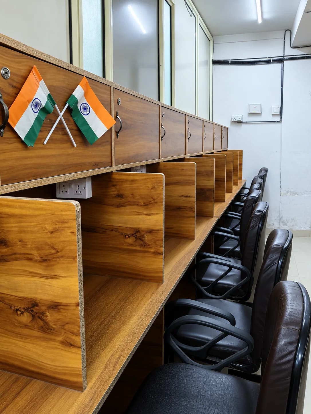 Private wooden study cubicles with Indian flags at Adhyayan Library