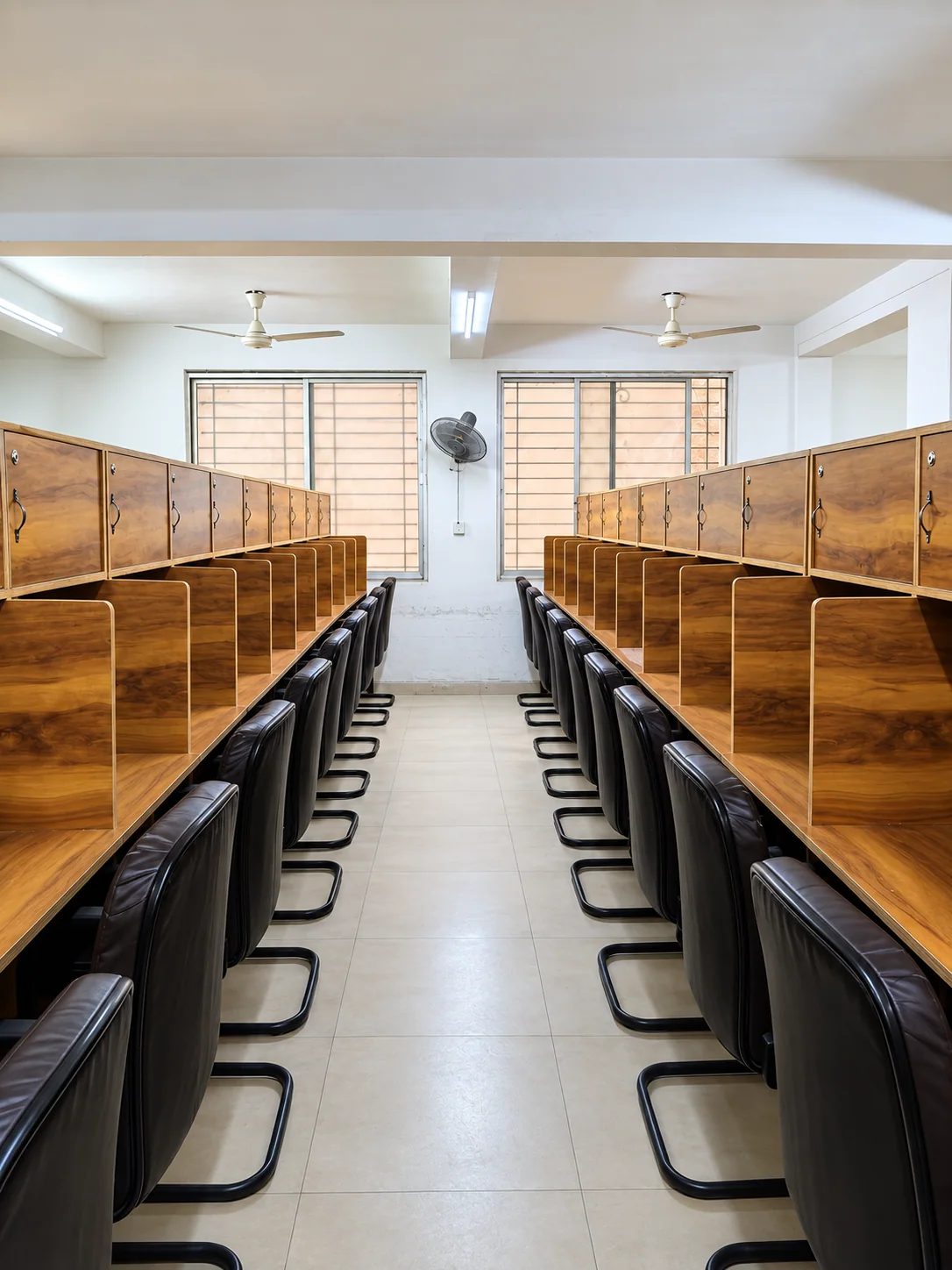 Bright AC study room with rows of dedicated desks in Padav